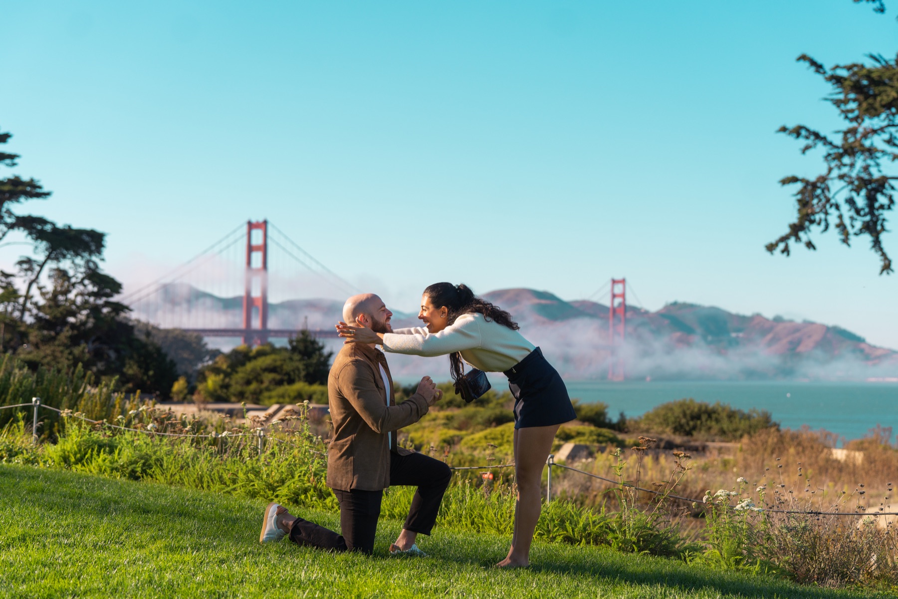Alex and Abby celebrating together after their Golden Gate Bridge proposal