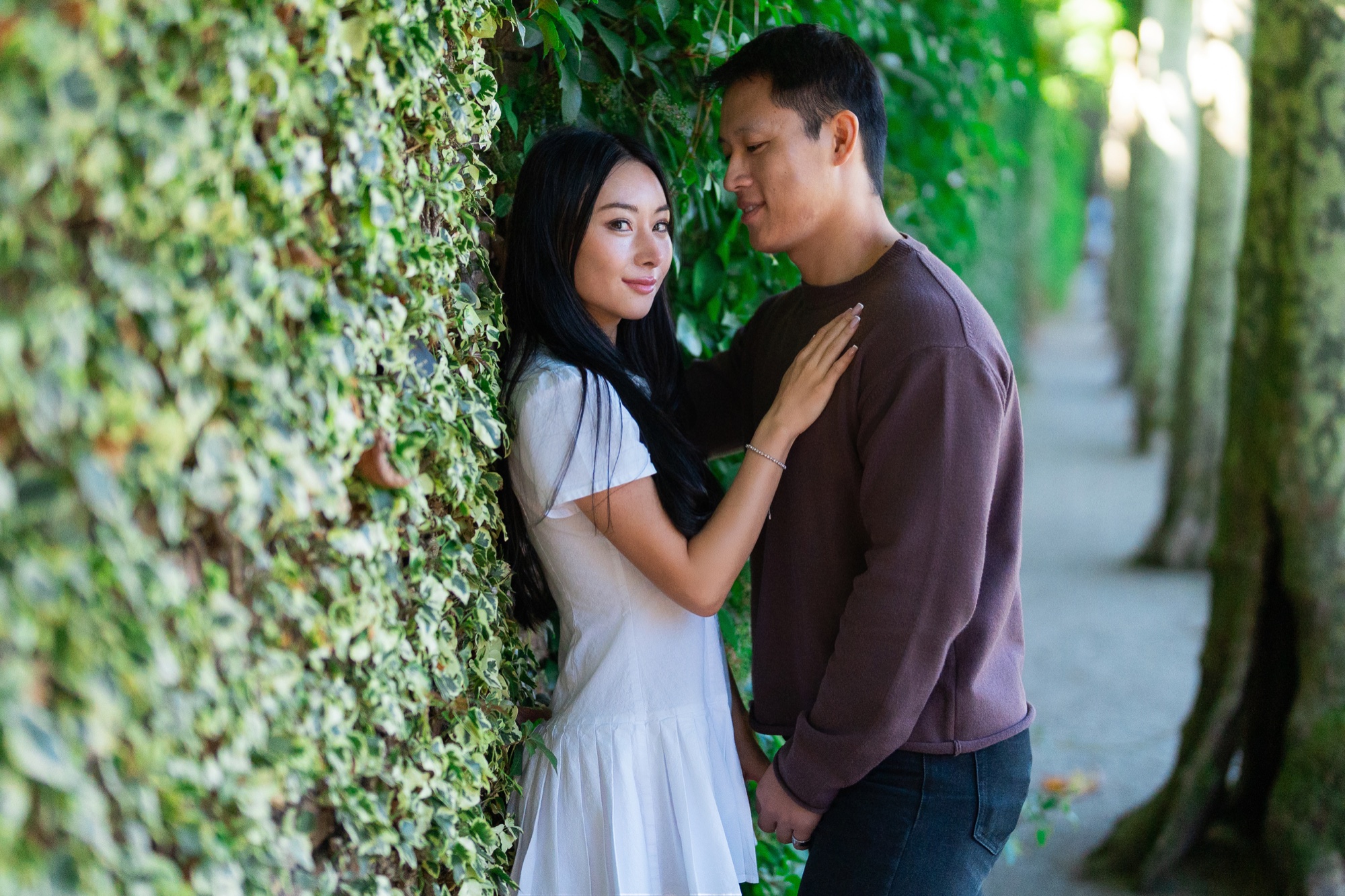 Ernest and Alexandra standing together beside an ivy-covered wall at Filoli