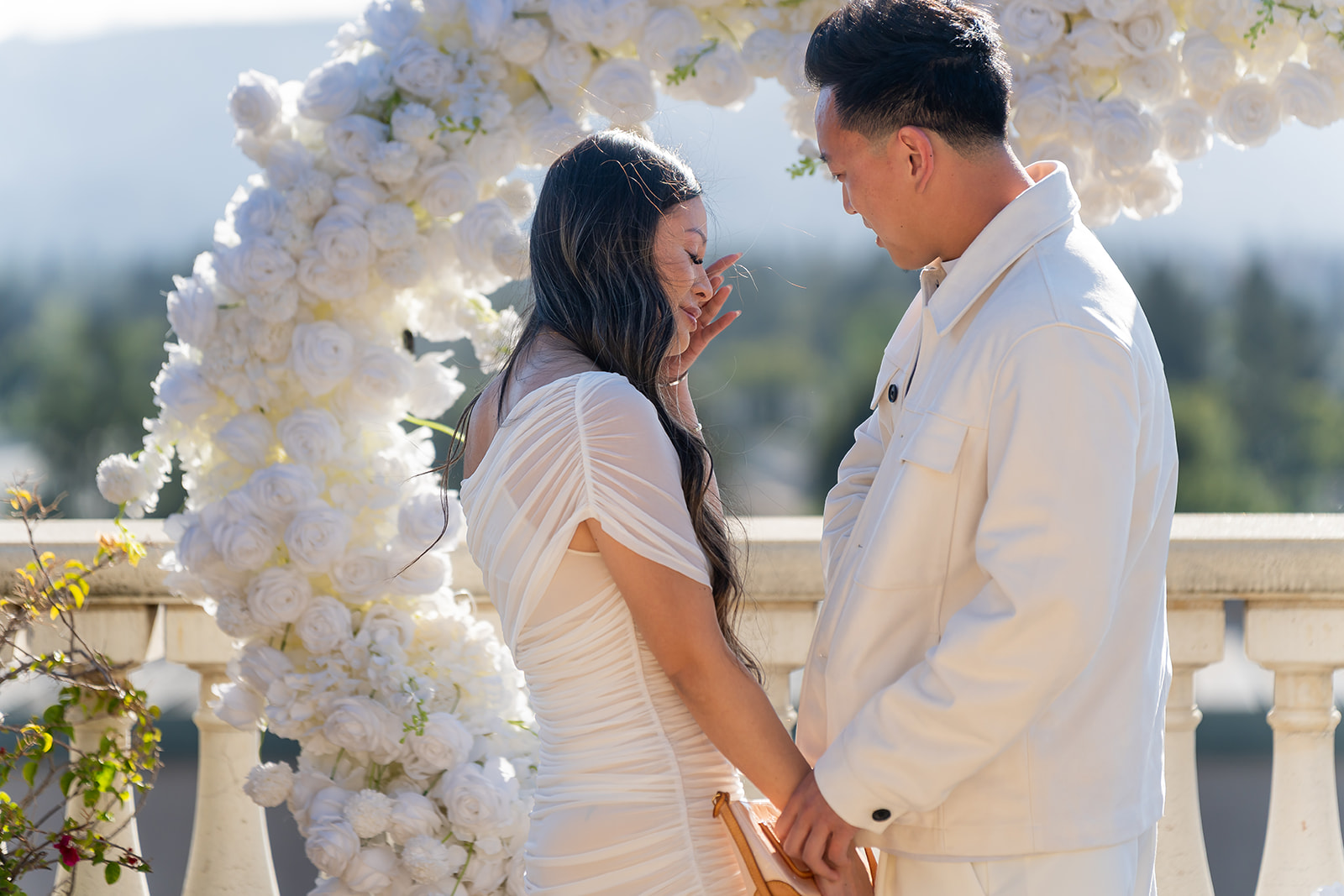 Engaged couple embracing at Cielo Rooftop at Santana Row in San Jose