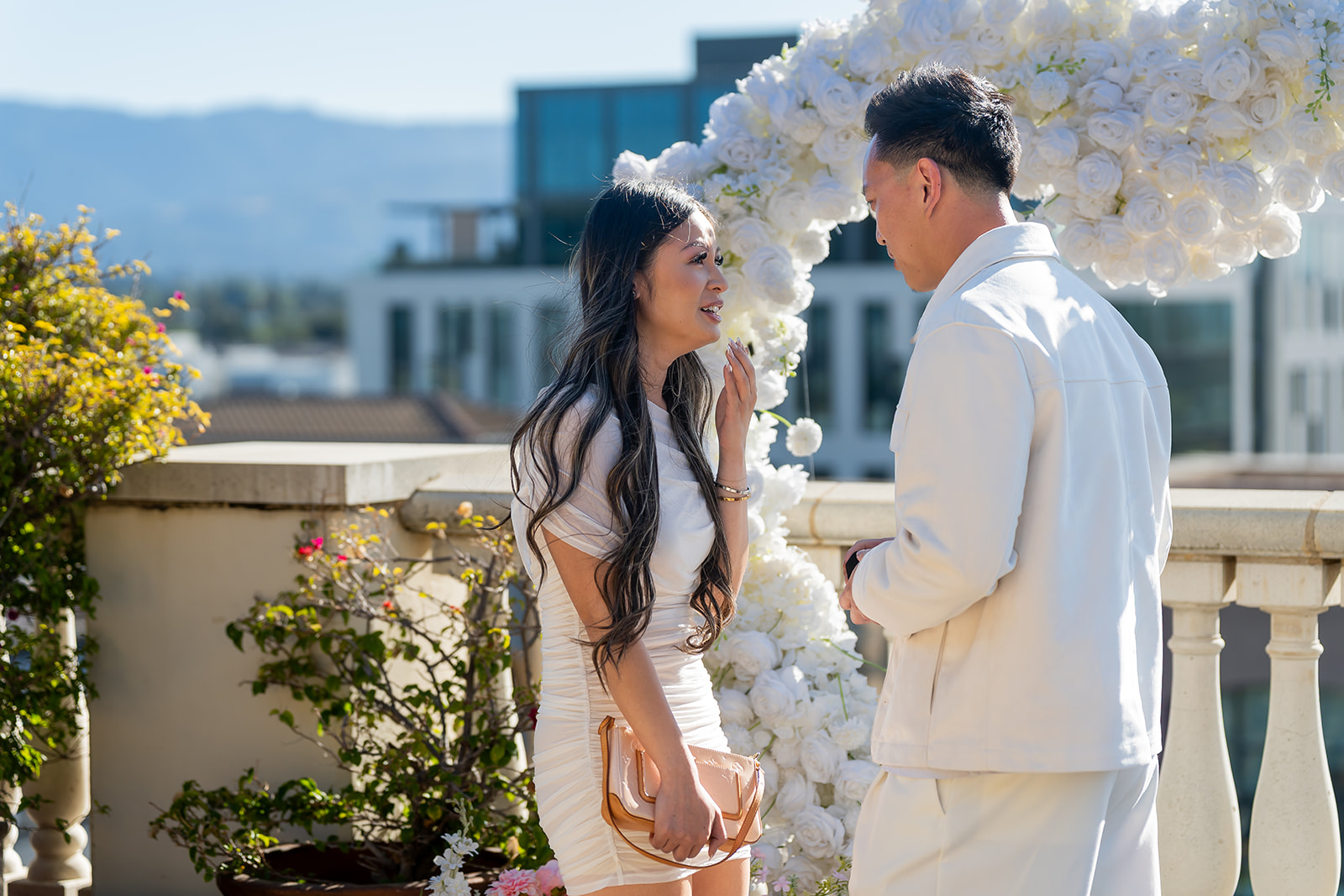Couple smiling together after a rooftop proposal at Santana Row in San Jose